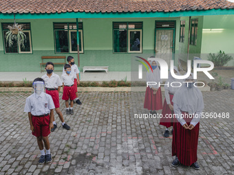 Students line up before entering the classroom at Candirejo Elementary School, Semarang Regency, Central Java, Indonesia, on September 1, 20...