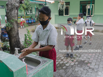 A student wash his hands before entering the classroom at Candirejo Elementary School, Semarang Regency, Central Java, Indonesia, on Septemb...