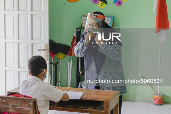 A teacher give explanation to a student at Candirejo Elementary School, Semarang Regency, Central Java, Indonesia, on September 1, 2020. Loc...