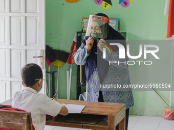 A teacher give explanation to a student at Candirejo Elementary School, Semarang Regency, Central Java, Indonesia, on September 1, 2020. Loc...