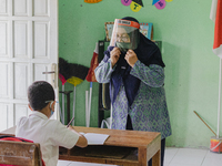 A teacher give explanation to a student at Candirejo Elementary School, Semarang Regency, Central Java, Indonesia, on September 1, 2020. Loc...