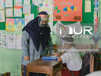 A teacher give explanation to a student at Candirejo Elementary School, Semarang Regency, Central Java, Indonesia, on September 1, 2020. Loc...