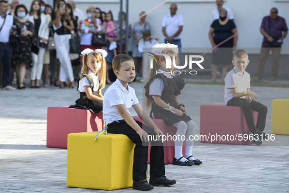 First graders sit on separate poufs for social distancing during a ceremony to mark the start of the new school year, amid the outbreak of t...