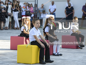 First graders sit on separate poufs for social distancing during a ceremony to mark the start of the new school year, amid the outbreak of t...