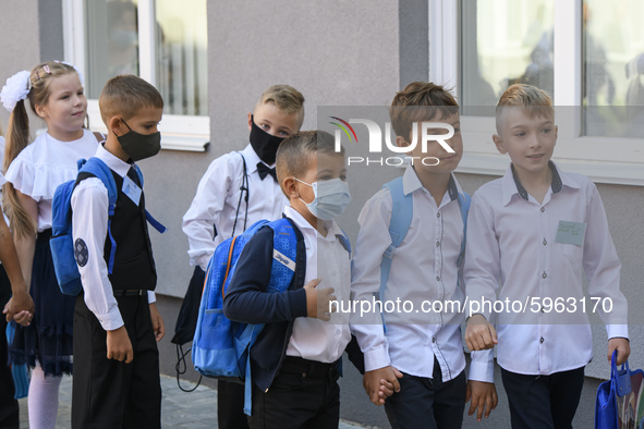 First graders wear protective face masks during a ceremony to mark the start of the new school year, amid the outbreak of the coronavirus di...