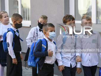 First graders wear protective face masks during a ceremony to mark the start of the new school year, amid the outbreak of the coronavirus di...