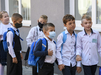 First graders wear protective face masks during a ceremony to mark the start of the new school year, amid the outbreak of the coronavirus di...