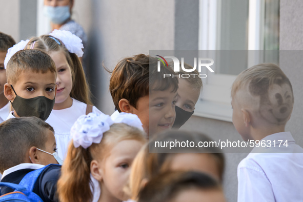 First graders wear protective face masks during a ceremony to mark the start of the new school year, amid the outbreak of the coronavirus di...