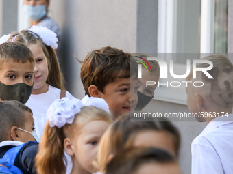 First graders wear protective face masks during a ceremony to mark the start of the new school year, amid the outbreak of the coronavirus di...