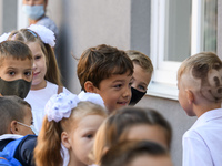 First graders wear protective face masks during a ceremony to mark the start of the new school year, amid the outbreak of the coronavirus di...