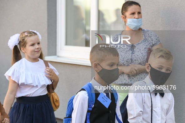 First graders wear protective face masks during a ceremony to mark the start of the new school year, amid the outbreak of the coronavirus di...