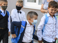 First graders wear protective face masks during a ceremony to mark the start of the new school year, amid the outbreak of the coronavirus di...