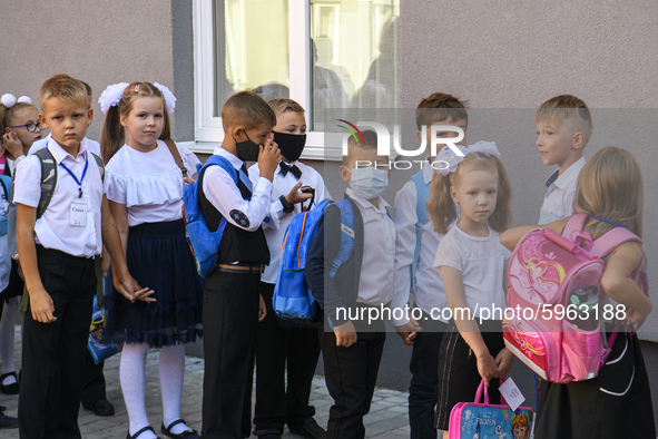 First graders wear protective face masks during a ceremony to mark the start of the new school year, amid the outbreak of the coronavirus di...