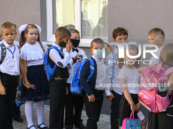 First graders wear protective face masks during a ceremony to mark the start of the new school year, amid the outbreak of the coronavirus di...