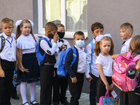 First graders wear protective face masks during a ceremony to mark the start of the new school year, amid the outbreak of the coronavirus di...