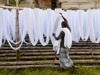 A worker dry fabric under the sun after dyeing them in a factory in Narayanganj, Bangladesh on September 03, 2020. (