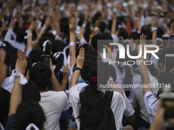 Thai students hold up a three finger salute as they protest against the government in front of the Ministry of Education, in Bangkok, Thaila...