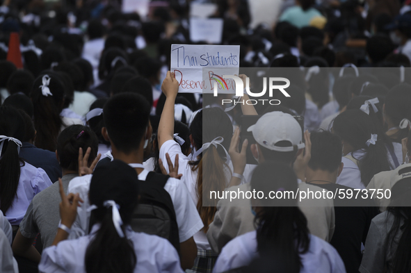 Thai students hold placards as they show support for the student-led democracy movement in front of the Ministry of Education, in Bangkok, T...