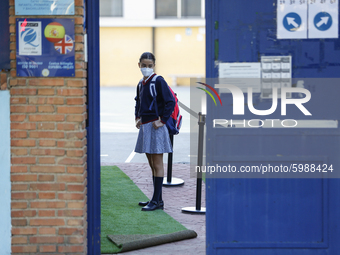 A girl with a facemask  entering to her education center during the first day of school on September 10, 2020 in Granada, Spain.  (