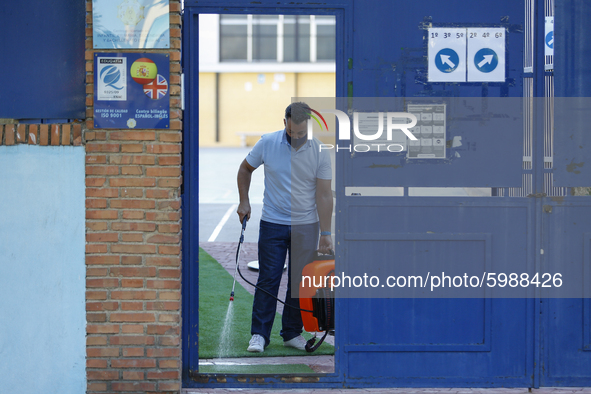 A worker with a facemask from an education center is disinfecting the floor during the first day of school on September 10, 2020 in Granada,...