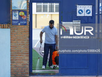 A worker with a facemask from an education center is disinfecting the floor during the first day of school on September 10, 2020 in Granada,...