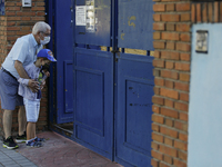 An old man and his grandchild wearing facemasks during the first day of school on September 10, 2020 in Granada, Spain.  (