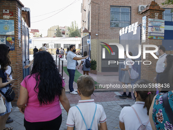 Many parents with their kids are waiting to enter to an education center during the first day of school on September 10, 2020 in Granada, Sp...