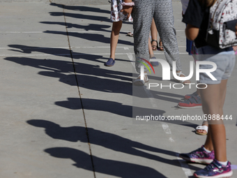 Many children with facemasks wait in some long queues to disinfect their hands during the first day of school on September 10, 2020 in Grana...