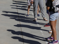 Many children with facemasks wait in some long queues to disinfect their hands during the first day of school on September 10, 2020 in Grana...