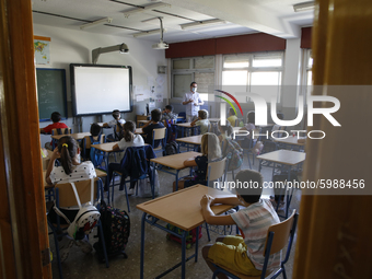 A teacher with a facemask teaching his students during the first day of school on September 10, 2020 in Granada, Spain.  (