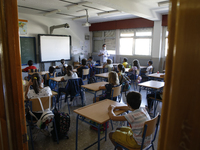 A teacher with a facemask teaching his students during the first day of school on September 10, 2020 in Granada, Spain.  (