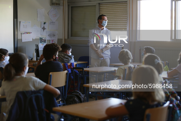 A teacher with a facemask teaching his students during the first day of school on September 10, 2020 in Granada, Spain.  