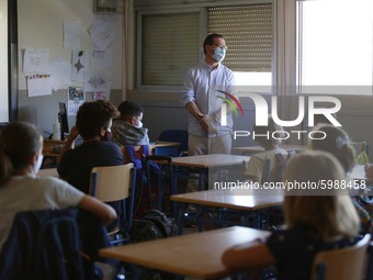 A teacher with a facemask teaching his students during the first day of school on September 10, 2020 in Granada, Spain.  (