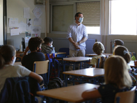 A teacher with a facemask teaching his students during the first day of school on September 10, 2020 in Granada, Spain.  (