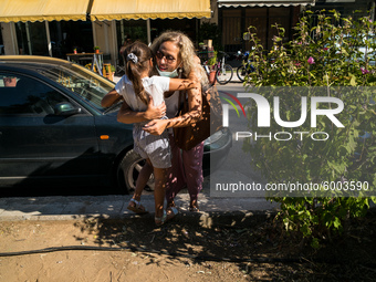 A mother hugs her daughter after finishing the first day in school, on September 14, 2020, Nea Ionia, Athens  (