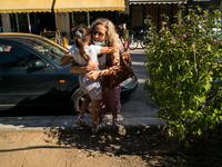 A mother hugs her daughter after finishing the first day in school, on September 14, 2020, Nea Ionia, Athens  (