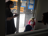 Students return for their first day of in-class schooling following the pandemic at New York City's Preschool of the Arts, having their temp...