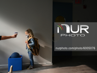 Students return for their first day of in-class schooling following the pandemic at New York City's Preschool of the Arts, having their temp...