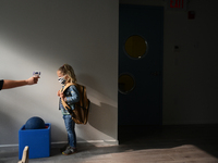 Students return for their first day of in-class schooling following the pandemic at New York City's Preschool of the Arts, having their temp...