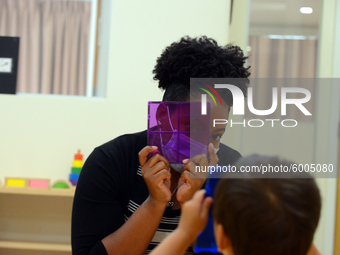 Masked students return for their first day of in-class schooling following the pandemic at New York City's Preschool of the Arts, with new c...