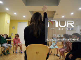 Masked students return for their first day of in-class schooling following the pandemic at New York City's Preschool of the Arts, with new c...