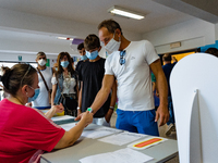 A collaborator measures the temperature of the students' parents to enter the Don Tonino Bello High School in Molfetta on 16th September 202...