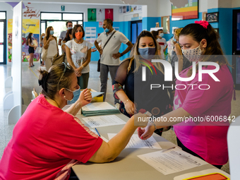 A collaborator measures the temperature of the students' parents to enter the Don Tonino Bello High School in Molfetta on 16th September 202...