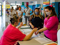 A collaborator measures the temperature of the students' parents to enter the Don Tonino Bello High School in Molfetta on 16th September 202...