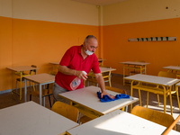 A janitor cleaning and disinfecting desks and the classroom in the Don Tonino Bello High School in Molfetta on 16th September 2020.
The reo...