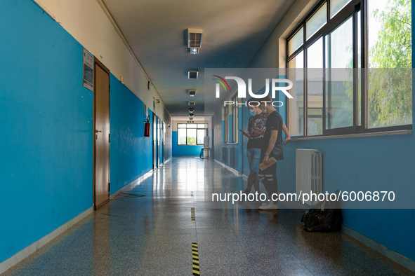 Students talking in the corridor with horizontal signs for distancing in the Don Tonino Bello High School in Molfetta on 16th September 2020...