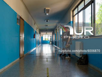 Students talking in the corridor with horizontal signs for distancing in the Don Tonino Bello High School in Molfetta on 16th September 2020...