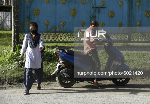 Father drop his daughter at school, in Nalbari, Assam, India on September 21, 2020 as schools reopened after more than 5-months closure due...