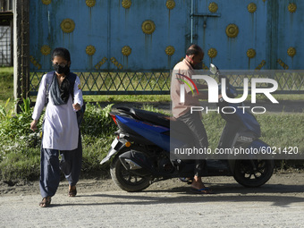 Father drop his daughter at school, in Nalbari, Assam, India on September 21, 2020 as schools reopened after more than 5-months closure due...