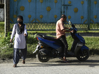 Father drop his daughter at school, in Nalbari, Assam, India on September 21, 2020 as schools reopened after more than 5-months closure due...